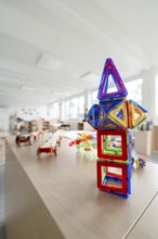 Colourful geometric toys on a table in a kindergarten, transitional daycare centre in container