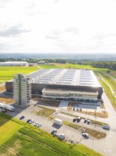 Modern factory complex with large-scale roof construction in a green landscape, ING Park