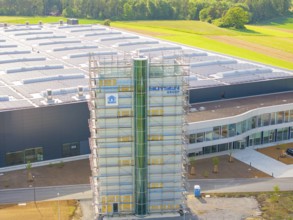 Industrial building with green surroundings and scaffolding, equipped with solar system, ING Park