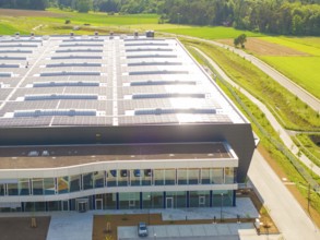 Roof of a large building with solar modules, surrounded by rural landscape, ING Park development