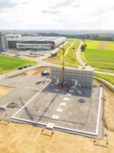 Large construction site with crane and unfinished structure in a rural setting, ING Park