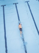 A swimmer in a large pool, concentrating on swimming his laps, Calw outdoor pool, Black Forest,