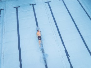 A single swimmer in the pool, calmly and steadily swimming his laps, Calw outdoor pool, Black
