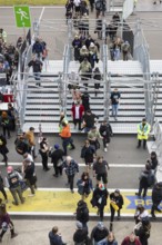 Festival visitors pass through a lock to get into the first breakwater at the Rock am Ring Festival