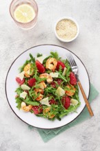 Fresh shrimp salad with arugula, grapefruit, and parmesan served in a bowl