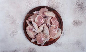 Raw chicken wings, on a wooden board, top view, no people