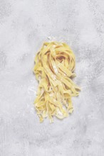 Raw tagliatelli pasta, homemade, top view, no people, rustic, food concept