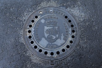 Manhole cover with city coat of arms of Medias, Romania