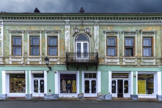 19th century house, restored shops on ground floor, upper floor not restored, Medias, Romania
