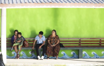 Guatemalans wait at the boat dock in Livingston on the Rio Dulce River, Izabal Department,