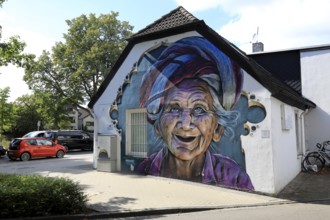 Graffiti portrait of an elderly woman from Bali. The work of art is part of the Kultur aus Tausch