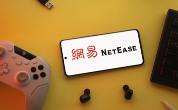 Dhaka, Bangladesh- 23 March 2025: NetEase logo displayed on a smartphone surrounded by gaming