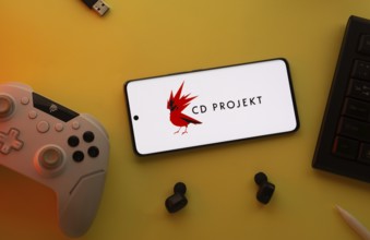 Dhaka, Bangladesh- 23 March 2025: CD Projekt logo displayed on a smartphone surrounded by gaming
