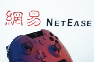 Dhaka, Bangladesh- 20 Mar 2025: A close-up of a gamepad with the NetEase seen on screen in the