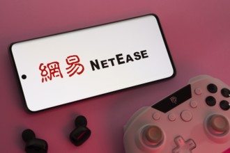 Dhaka, Bangladesh- 08 Apr 2025: A smartphone displaying the NetEase logo next to a gaming
