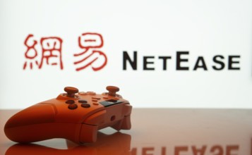Dhaka, Bangladesh- 20 Mar 2025: A close-up of a gamepad with the NetEase seen on screen in the