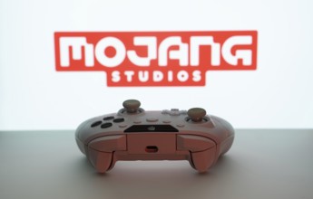 Dhaka, Bangladesh- 08 Apr 2025: A gaming controller in front of a Mojang Studios screen