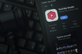 Dhaka, Bangladesh- 28 Oct 2025: An iPad displaying the Youtube Studio app against a judge's gavel