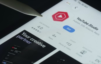 Dhaka, Bangladesh- 30 Oct 2025: Youtube Studio app on a iPad screen with a pen pointing at the