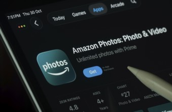 Dhaka, Bangladesh- 30 Oct 2025: Amazon photos app displayed on a iPad screen in dark mode with a
