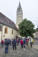 Tour group in the courtyard of St. Margaret's Church, Medias, Romania