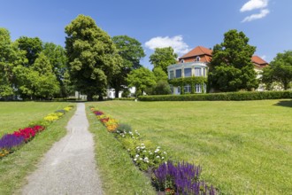 Colourful blooming flower beds in the castle park with the New Castle in the background, Pulsnitz,