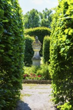 Visual axis through arcades to an ornamental sandstone vase, Pulsnitz Castle Park, Saxony, Germany