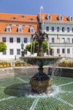 Sandstone market fountain on the medieval market square, in the background the monument to the