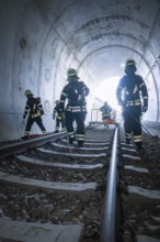 Firefighters in a tunnel on rails during an operation, fire brigade exercise on the Hermann Hesse