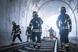 Firefighters in a tunnel working on rails, fire brigade exercise on the Hermann Hesse Railway,