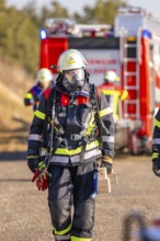 Firefighter wearing respirator and equipment during an operation, fire brigade exercise on the