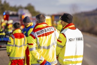 Rescue workers and firefighters discuss during an emergency operation, fire brigade exercise on the