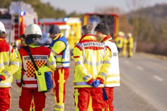 Group of rescue workers and firefighters on a street during an emergency operation, fire brigade