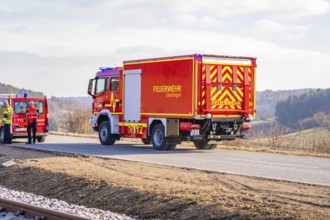 Red fire engine on a rural road in clear winter skies, fire department exercise on the Hermann