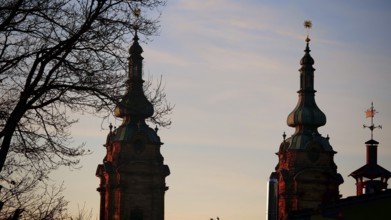 Church towers at sunset as silhouettes against a pastel-coloured sky, Franconian Forest nature park