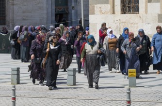 Group of woman in traditional Islamic dress in a square, woman after prayer at Konya Sultan Selim