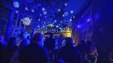 Night atmosphere with magical blue lights and people at a party, Kronach glows, Frankenwald nature