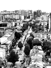 Aerial view of an urban environment with high-rise buildings and roads in black and white,