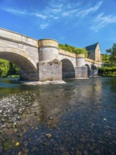 13th century medieval stone bridge across the Werra river, in the back the Liborius chapel,