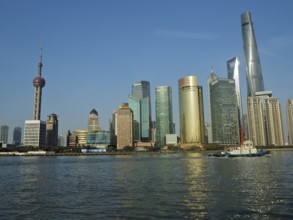 Modern urban skyline of Huangpu Jiang on the water under clear blue sky, Pudong, Shanghai, China
