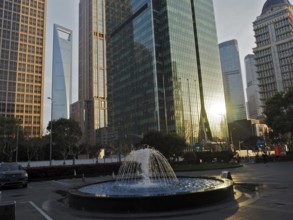 Skyscrapers with reflective glass facades and a fountain in the city center, Pudong, Shanghai,
