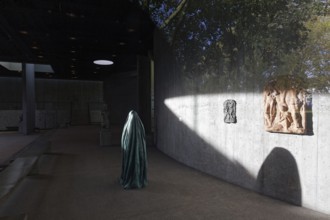 Statue of a veiled figure in the Lehmbruck Museum, looking through window, self-portrait as a ghost