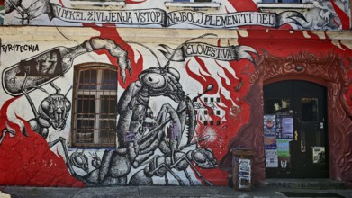 Distinctive black and red wall painting with insect motifs and urban graffiti, Ljubljana, Slovenia