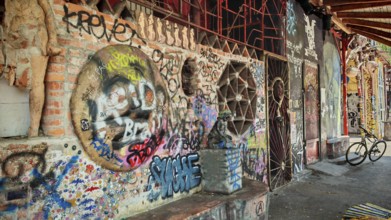 A mix of graffiti, art and bicycles on an urban brick wall with colors, Ljubljana, Slovenia