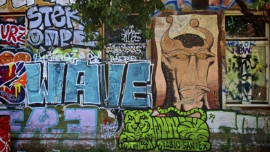 Colourful graffiti with various motifs on a brick wall in an urban environment, Ljubljana, Slovenia