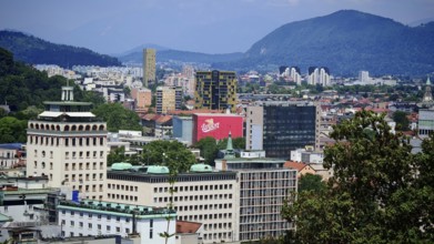 Urban landscape with modern buildings and mountain views in the background, city view of Ljubljana,