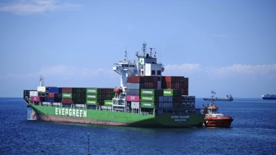 A large container ship on the high seas under a bright blue sky, Koper, Slovenia