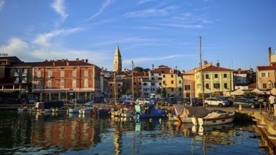 A picturesque harbor with boats and historic buildings at sunset, Izola, Slovenia