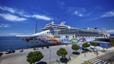 A large cruise ship is moored in the port of Koper under a clear blue sky, Slovenia