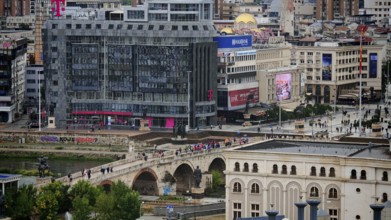 View of a city with a modern building and a bridge, Skopje, North Macedonia